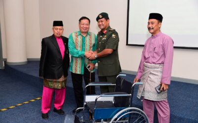 HANDING OVER WHEELCHAIRS TO RBAF RETIREES